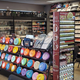 Inside Cosmic Games, featuring packed shelves and paint for miniatures.